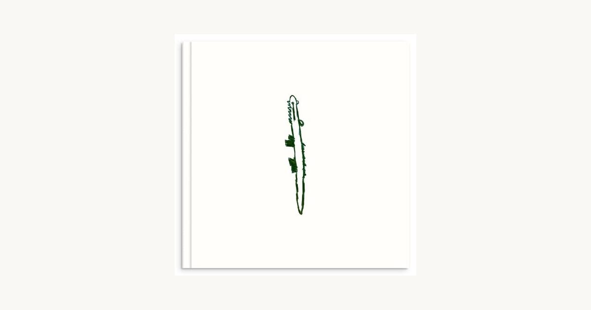 Hardcover photo book with a child's green drawing on the cover