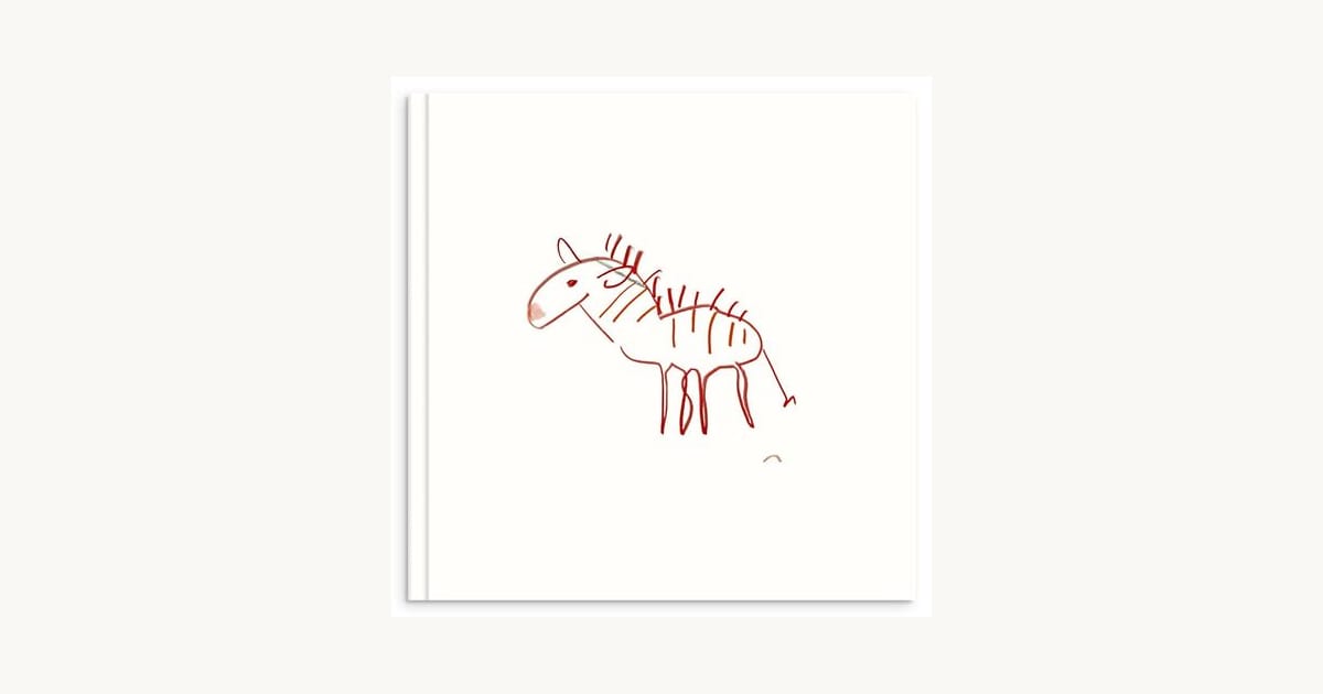 Hardcover photo book with a child's red dinosaur drawing on the cover